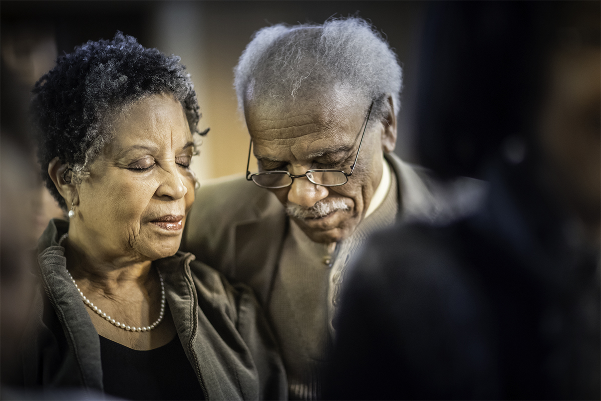 Two seniors praying