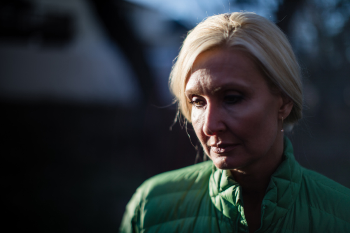 Adult daughter quietly thinking while looking depressed
