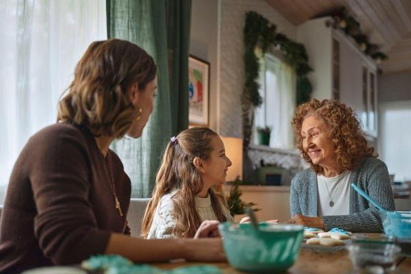 Grandparent with dementia sharing a joyful moment with grandchild – intergenerational connection and caregiving support.