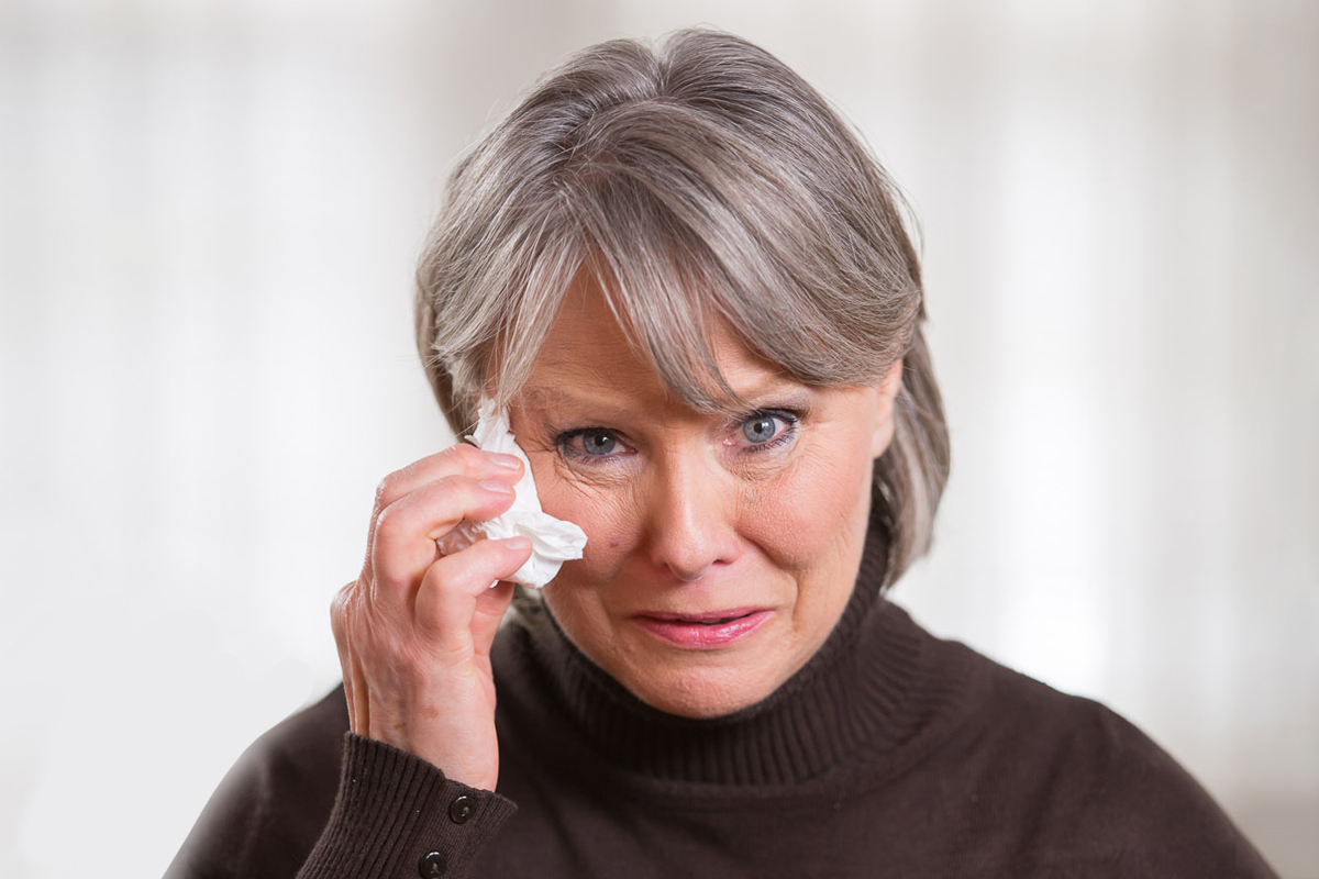 Woman wiping away tears